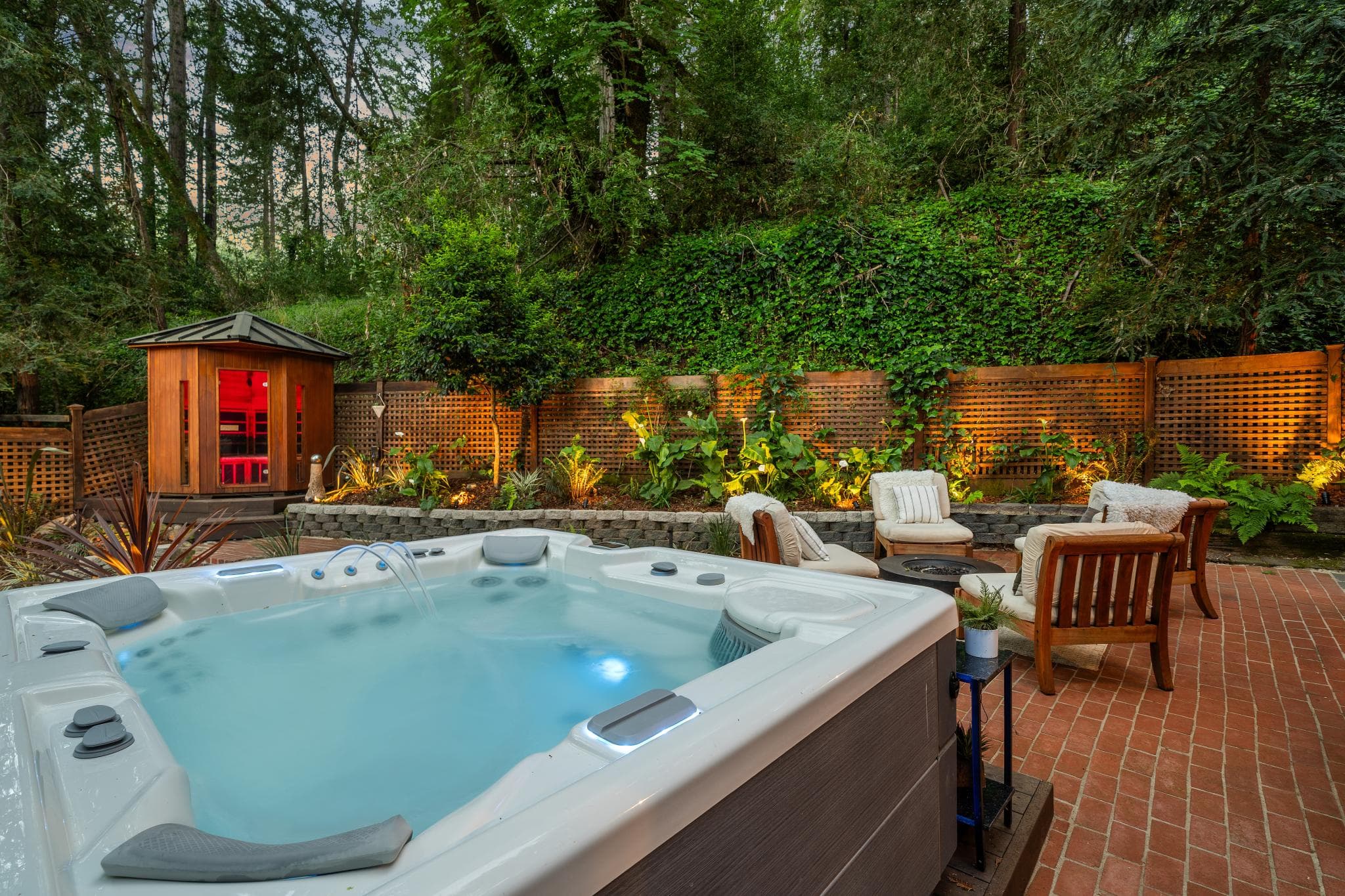 Guest relaxing in hot tub overlooking Napa Valley at sunset